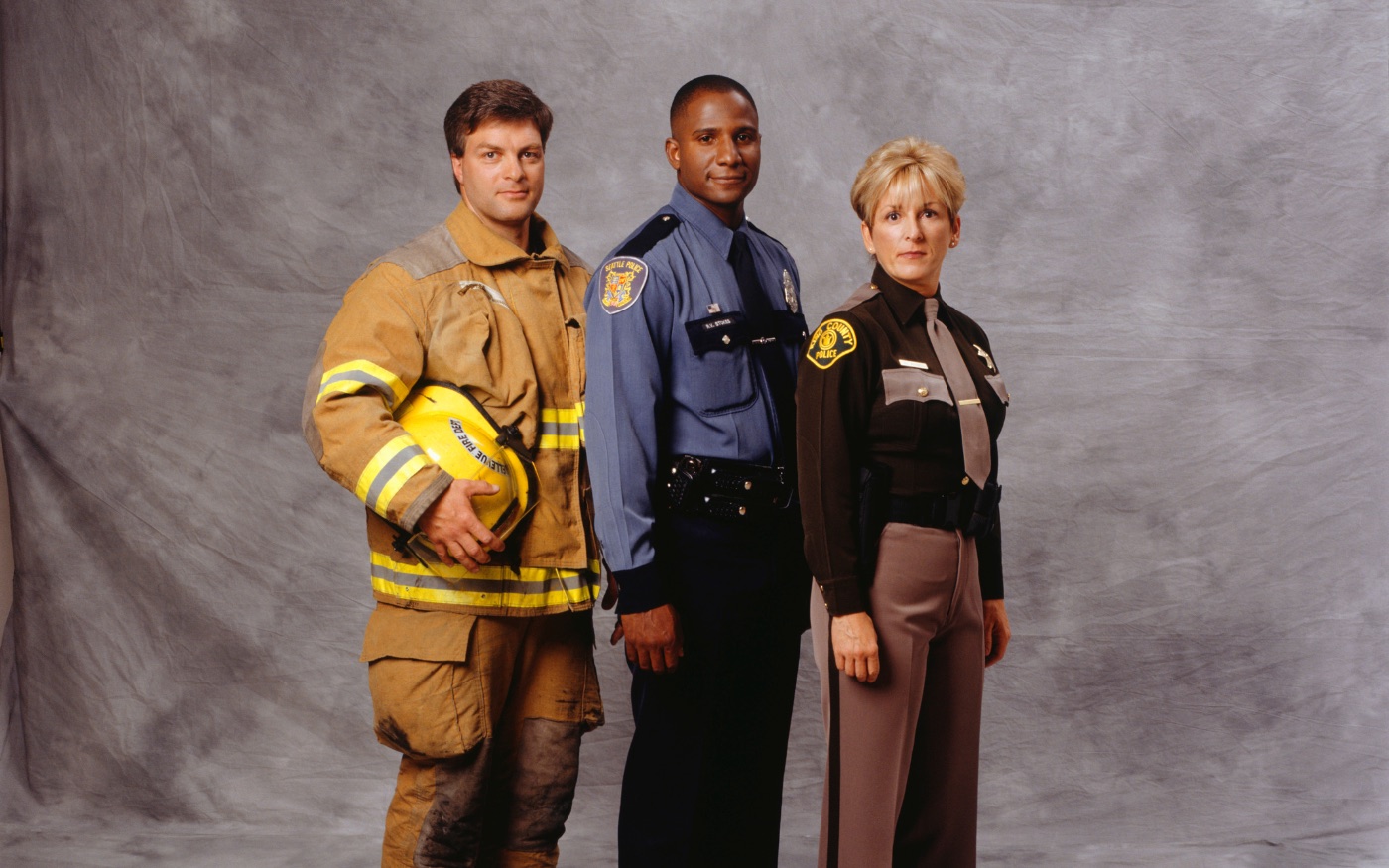 A firefighter, a police officer and a sheriff's deputy standing together